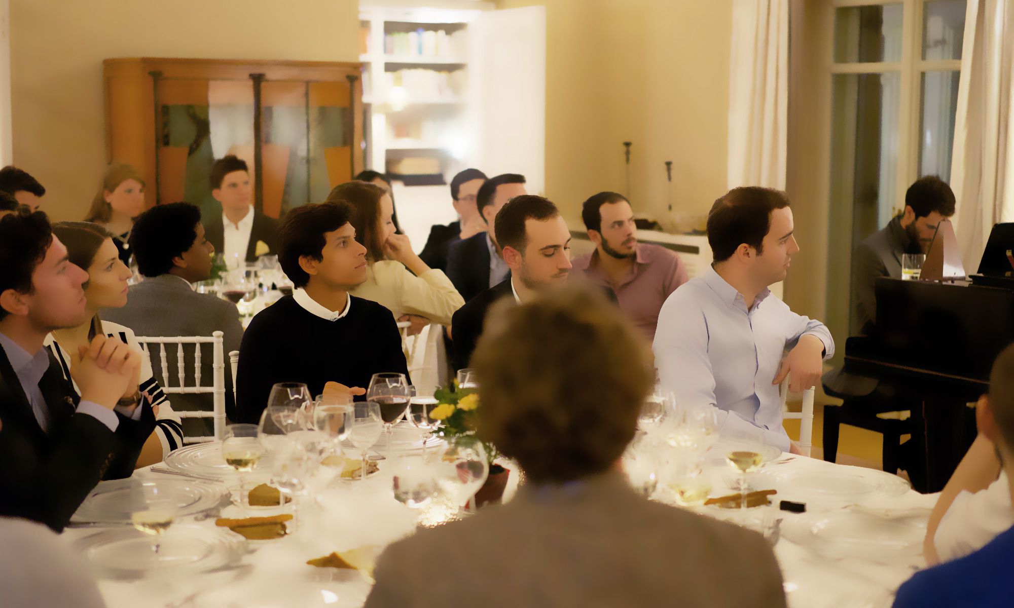 An evening salon gathering by candlelight